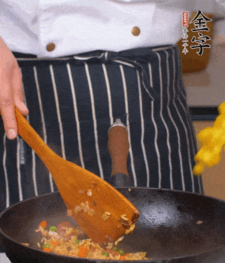 加咖喱块、少许盐、白糖调味，炒至咖喱块融化后，倒米饭，翻炒至每粒米饭都包裹上咖喱，再放黄椒、青椒粒，出锅前加菠萝粒和小葱翻拌均匀。