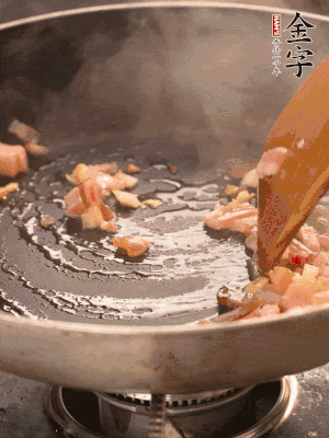热油爆香大蒜粒，煸香咸肉丁，淋一勺黄酒调味。